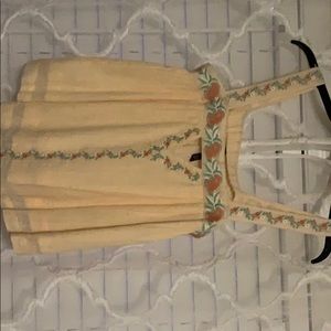 Peach tank. Floral embellishments.